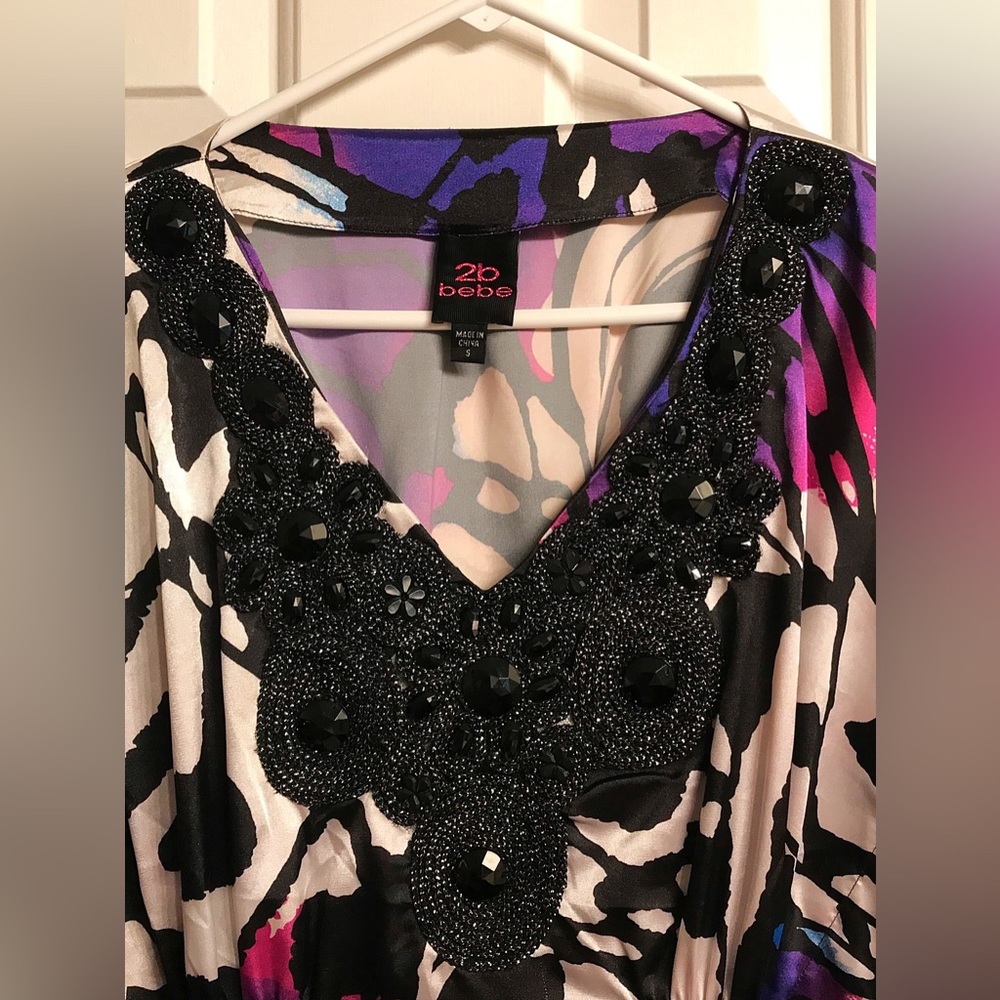 Dress Light Flowing Material, Beaded Neckline and Bell Sleeves all the way Down.